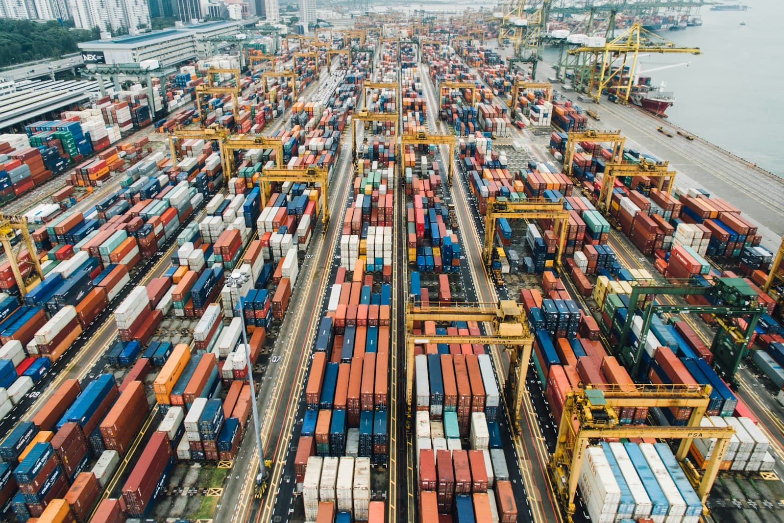 Container stacks and gantry cranes at a busy port terminal